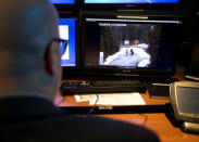 A telecommunications operator reenacts procedure for an illegal U.S.- Canada border crossing seen in their operational control centre at Royal Canadian Mounted Police (RCMP) headquarters in Montreal, Quebec Canada February 20, 2017. REUTERS/Christinne Muschi