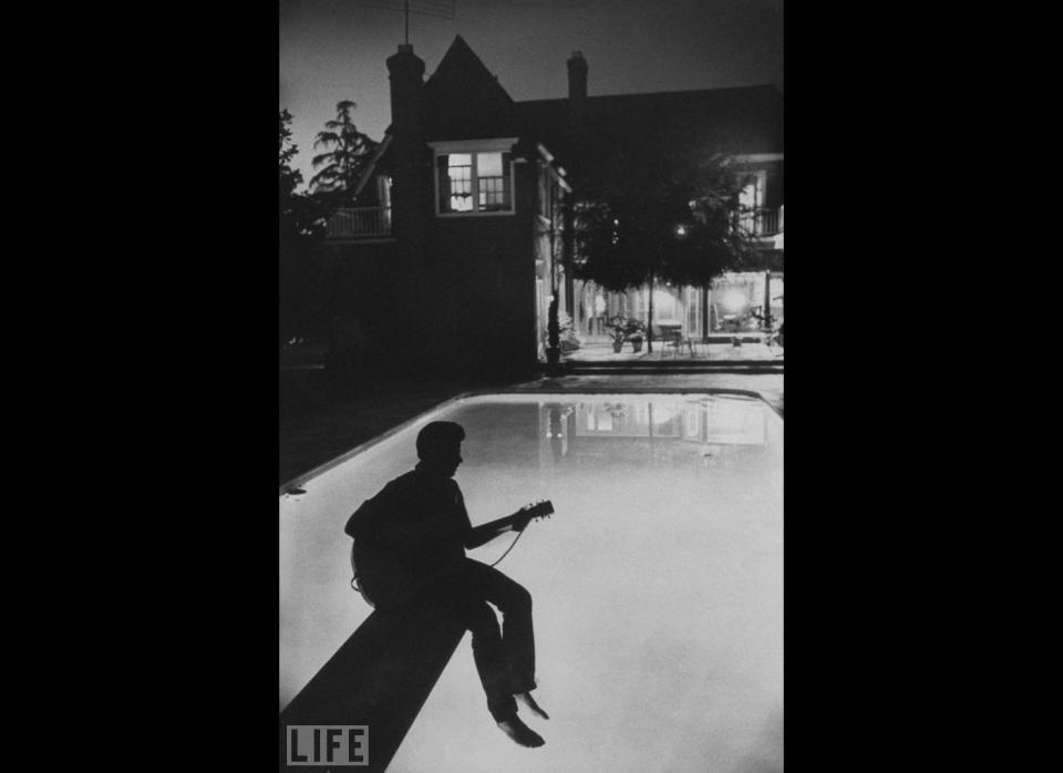 17-year-old Ricky Nelson playing his guitar in the backyard of his family's home in 1958.