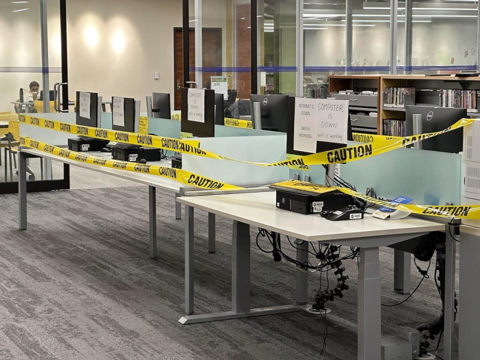 A view of Toronto Public Library computers, wrapped in yellow caution tape, at its Eglinton Square branch on Dec. 23.