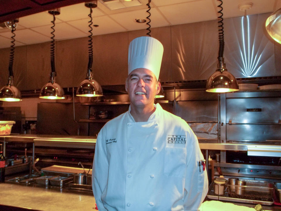 In this undated photo provided by The Capital Grille, chef Jeff Ansorge poses for a photo at the grill in Minneapolis. Ansorge, who used to command a staff of 17 at the posh downtown Minneapolis restaurant making nearly $80,000 a year, gave it all up to become the cook in charge of a Salvation Army soup kitchen where the meals are free and he makes a third of his previous salary. (AP Photo/The Capital Grille)