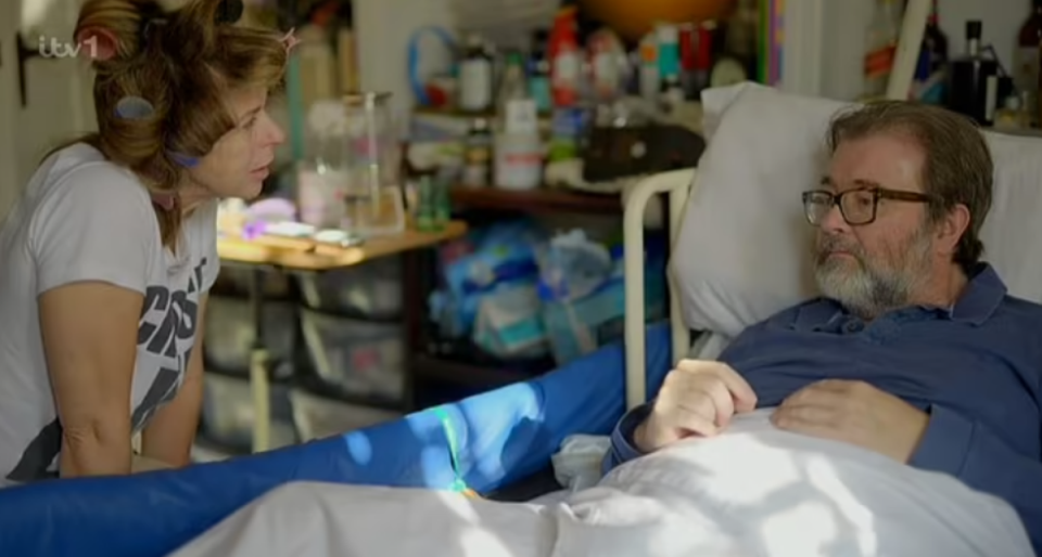 Kate Garraway pictured with husband Derek Draper at his bedside in ITV documentary Derek’s Story (ITV)