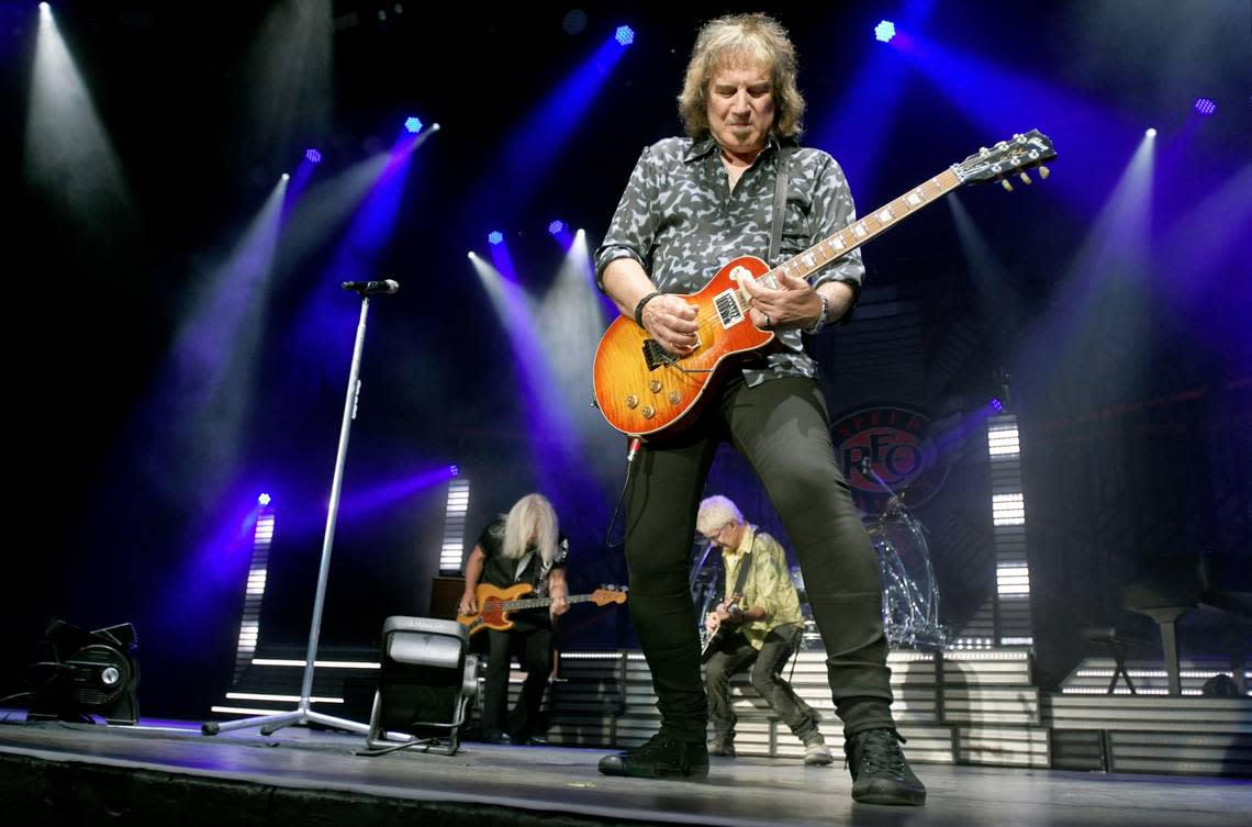 REO Speedwagon’s Dave Amato takes the spotlight as bandmates Bruce Hall and Kevin Cronin jam in the background at Raleigh, N.C.’s Coastal Credit Union Music Pavilion at Walnut Creek, Wednesday night, Aug. 10, 2022.