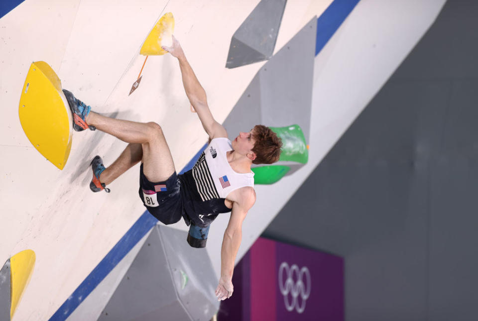 Duffy climbing up a wall during the Sport Climbing Men's Combined, Bouldering Qualification