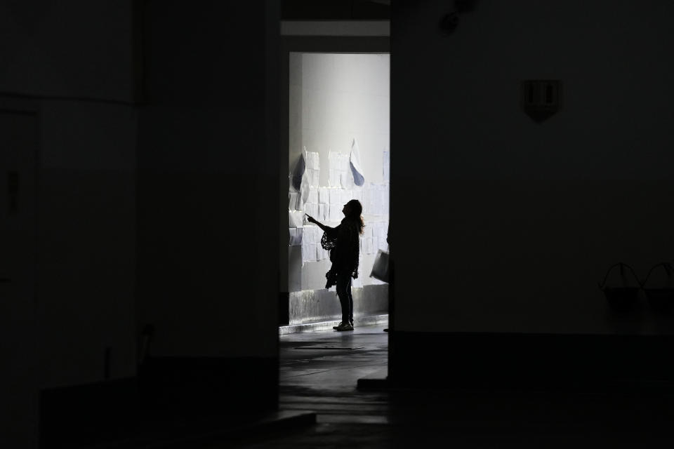 A voter looks at electoral lists during a presidential runoff election between Javier Milei and Sergio Massa in Buenos Aires, Argentina, Sunday, Nov. 19, 2023. (AP Photo/Matias Delacroix)