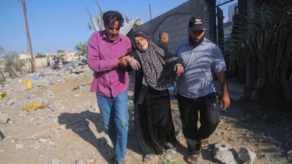 PHOTO: Palestinians evacuate a wounded woman after an Israeli airstrike in Rafah, Gaza Strip, Oct. 13, 2023. (Hatem Ali/AP)