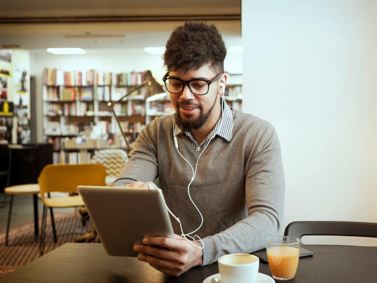 Man reading eBook in library