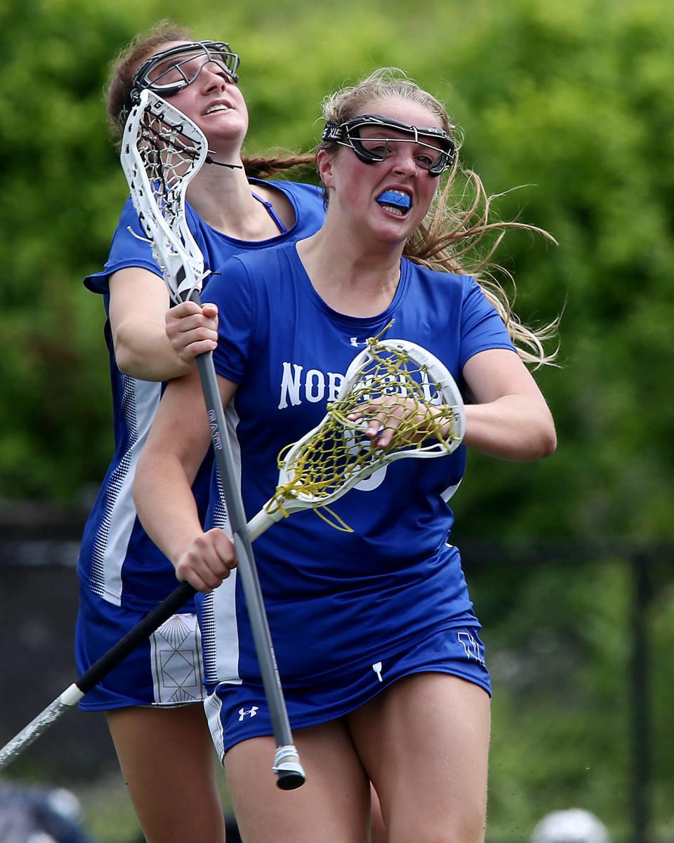 Norwell's Reese Stoddard jumps on Norwell's Danielle Cox after she scored a goal to cut Newburyport’s lead to 6-5 during first half action of their game against Newburyport in the Division 3 state final at Burlington High on Saturday, June 18, 2023. Norwell fell to Newburyport 13-10.