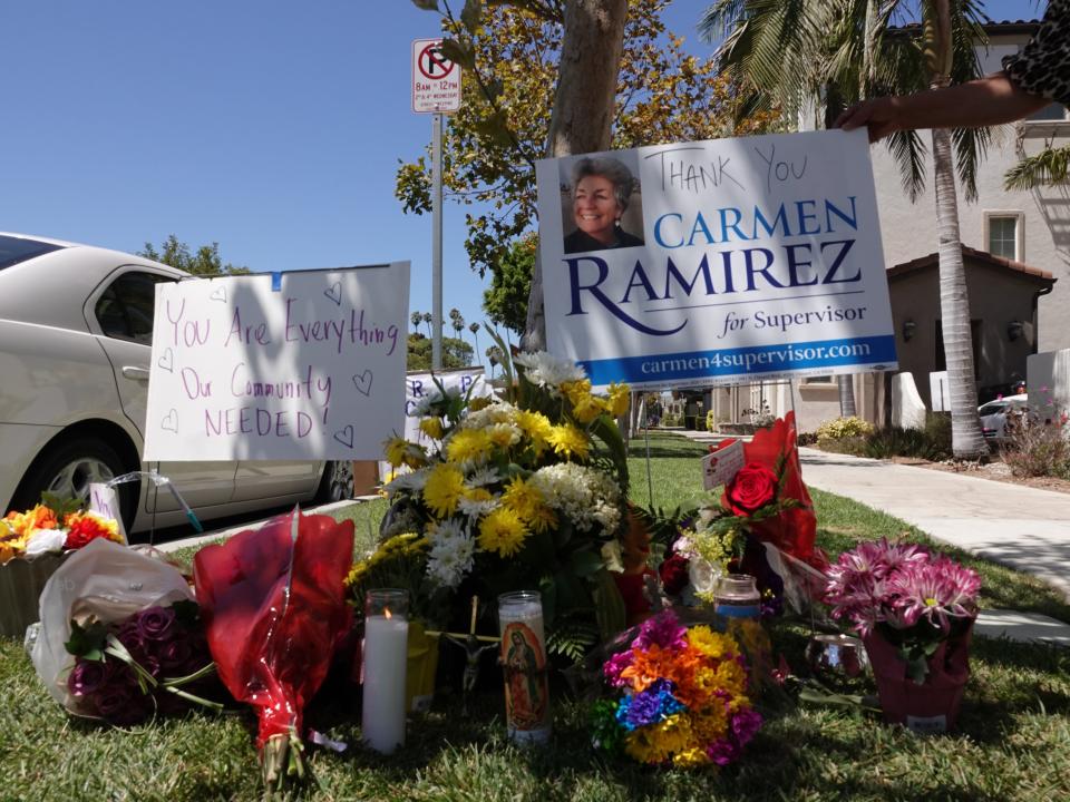 Mourners left flowers, candles and signs honoring Carmen Ramirez at the intersection where she was fatally struck by a pickup truck in downtown Oxnard on the night of Aug. 12.