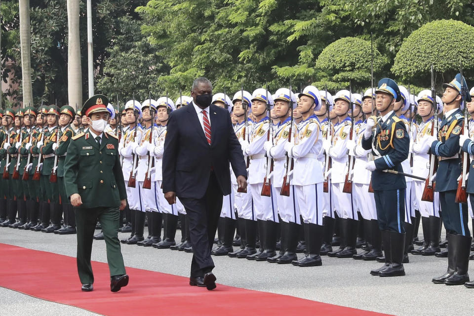 U.S. Secretary of Defense Lloyd Austin with Vietnamese Defense Minister Phan Van Giang, left, inspects an honor guard in Hanoi, Vietnam, Thursday, July 29, 2021. Austin is seeking to bolster ties with Vietnam, one of the Southeast Asian nations embroiled in a territorial rift with China, during a two-day visit. (Nguyen Trong Duc/VNA via AP)