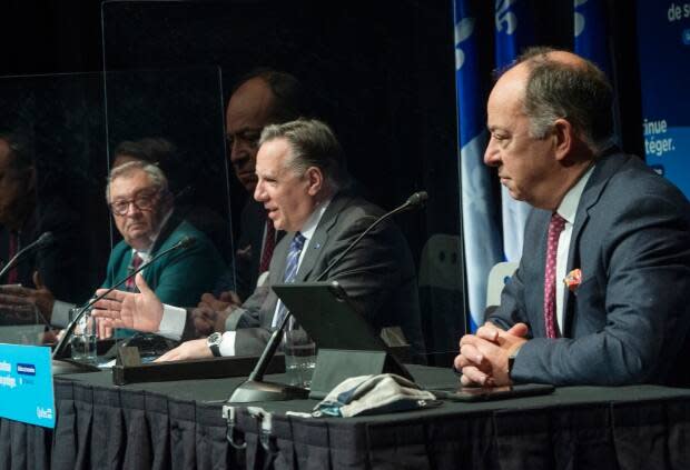 Quebec Health Director Horacio Arruda, left, Quebec Premier François Legault  and Health Minister Christian Dubé, right, at a news conference in Montreal on Wednesday. (Ryan Remiorz/The Canadian Press - image credit)