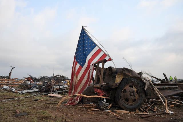 <p>Annie Rice / USA TODAY NETWORK</p> A United States flag displayed over the debris.