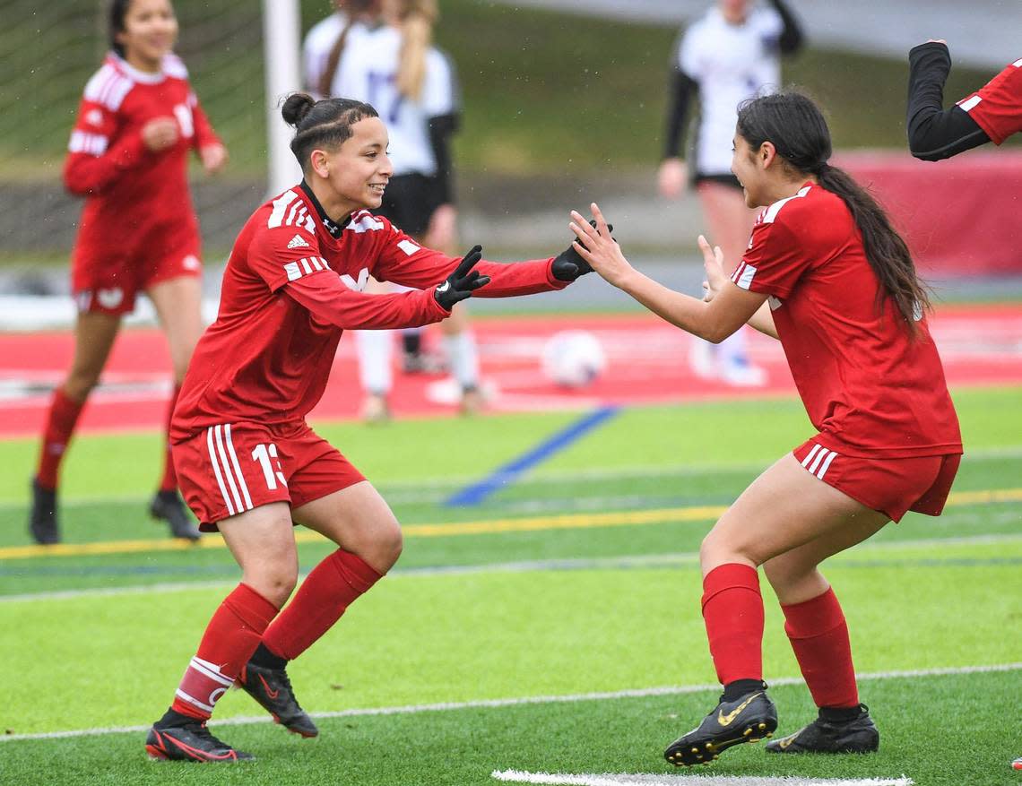 McLane’s Yadira Dominguez, left, celebrates her first goal against Desert with teammate Adrianna Villalvazo during their Central Section playoff game at McLane Stadium on Monday, Feb. 27, 2023.