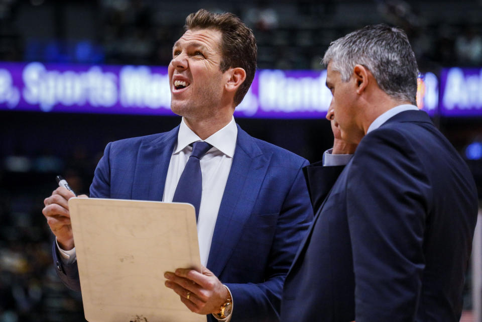 Sacramento Kings coach Luke Walton, left, looks at the scoreboard during a timeout in the first half of an NBA basketball game against the Denver Nuggets, Sunday, Dec. 29, 2019 in Denver. (AP Photo/Joe Mahoney)