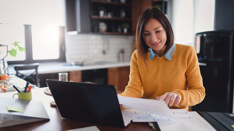 Person working on laptop in kitchen