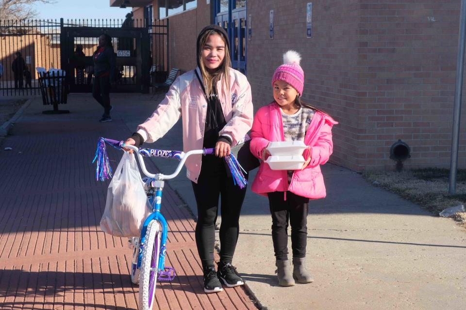 A happy recipient walks out with a new bicycle Saturday at the 10th annual Northside Toy Drive held at the Palo Duro High School Gym in Amarillo.