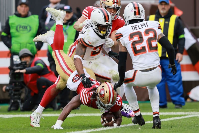 San Francisco 49ers running back Jordan Mason (bottom) dives into the end zone for a touchdown against the Cleveland Browns on Sunday in Cleveland. Photo by Aaron Josefczyk/UPI