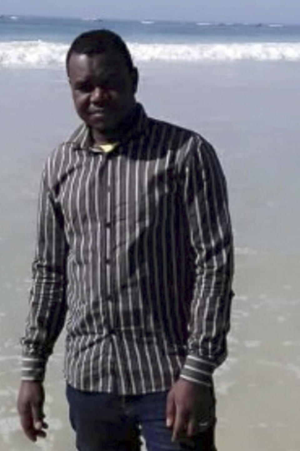 This undated photo provided by his family shows Alassane Sow on the beach in Nouakchott, Mauritania. Sow went missing on the night of Jan. 12, 2021, after boarding a boat from Mauritania in an attempt to reach Europe's Canary Islands. His body was found more than four months later near Trinidad and Tobago, after his boat drifted across the Atlantic. (Family photo via AP)