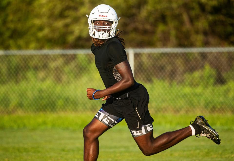 Kalonji Hamilton, a player for the Dunbar High School football team practices with his team on Wednesday, July 31, 2024.