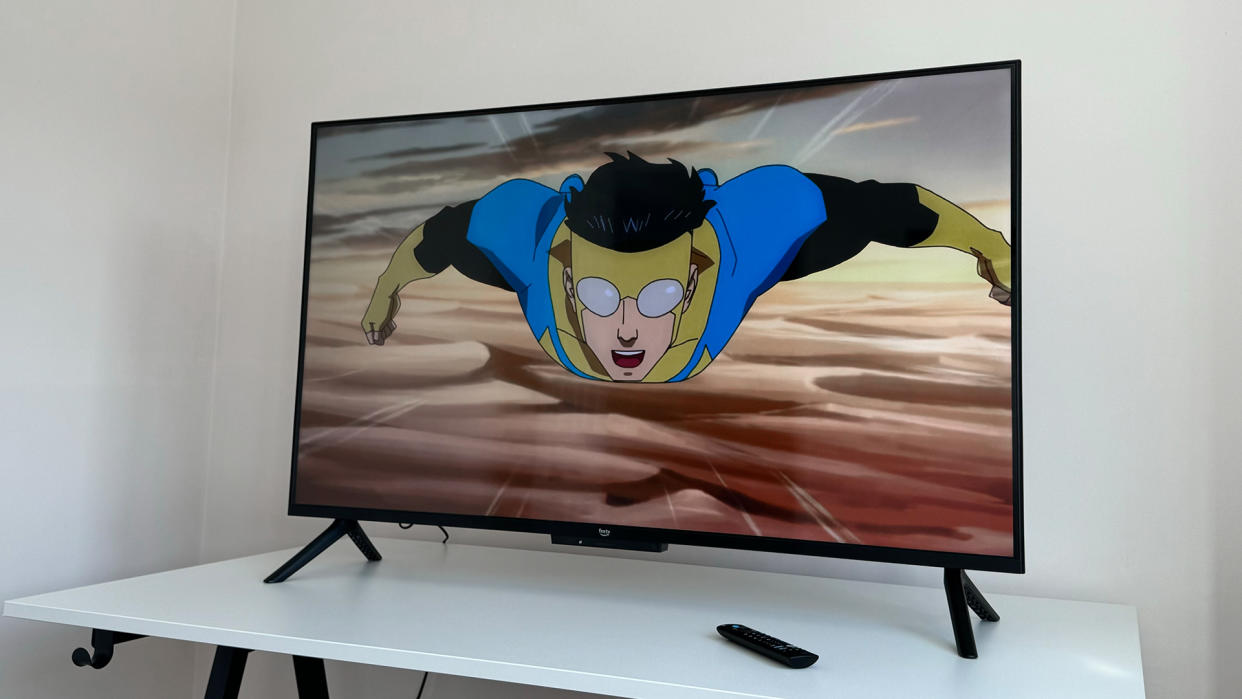  The 50-inch Amazon Fire TV Omni QLED on a white table with an image from animated TV show Invincible on the screen. 