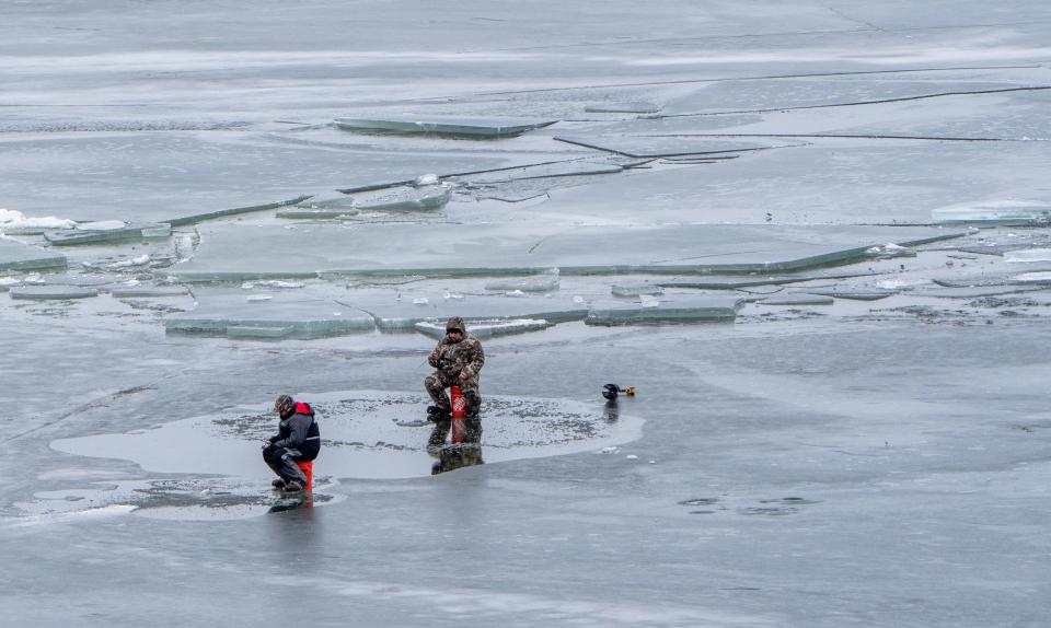 Ice fishermen stay close to shore off of Bay Shore Park in New Franken, Wisconsin, in January, which saw relatively little ice cover on the Great Lakes.