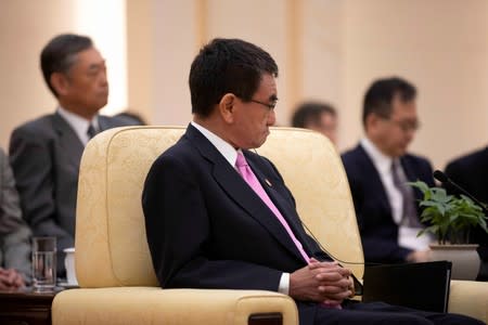 Japanese Foreign Minister Taro Kono listens during the meeting with Chinese Premier Li Keqiang and South Korean Foreign Minister Kang Kyung-wha at the Great Hall of the People (GHOP) in Beijing