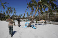 Project DYNAMO crews survey the island during their rescue operations of residents, in the wake of Hurricane Ian, Friday, Sept. 30, 2022, on Sanibel Island, Fla. (AP Photo/Steve Helber)