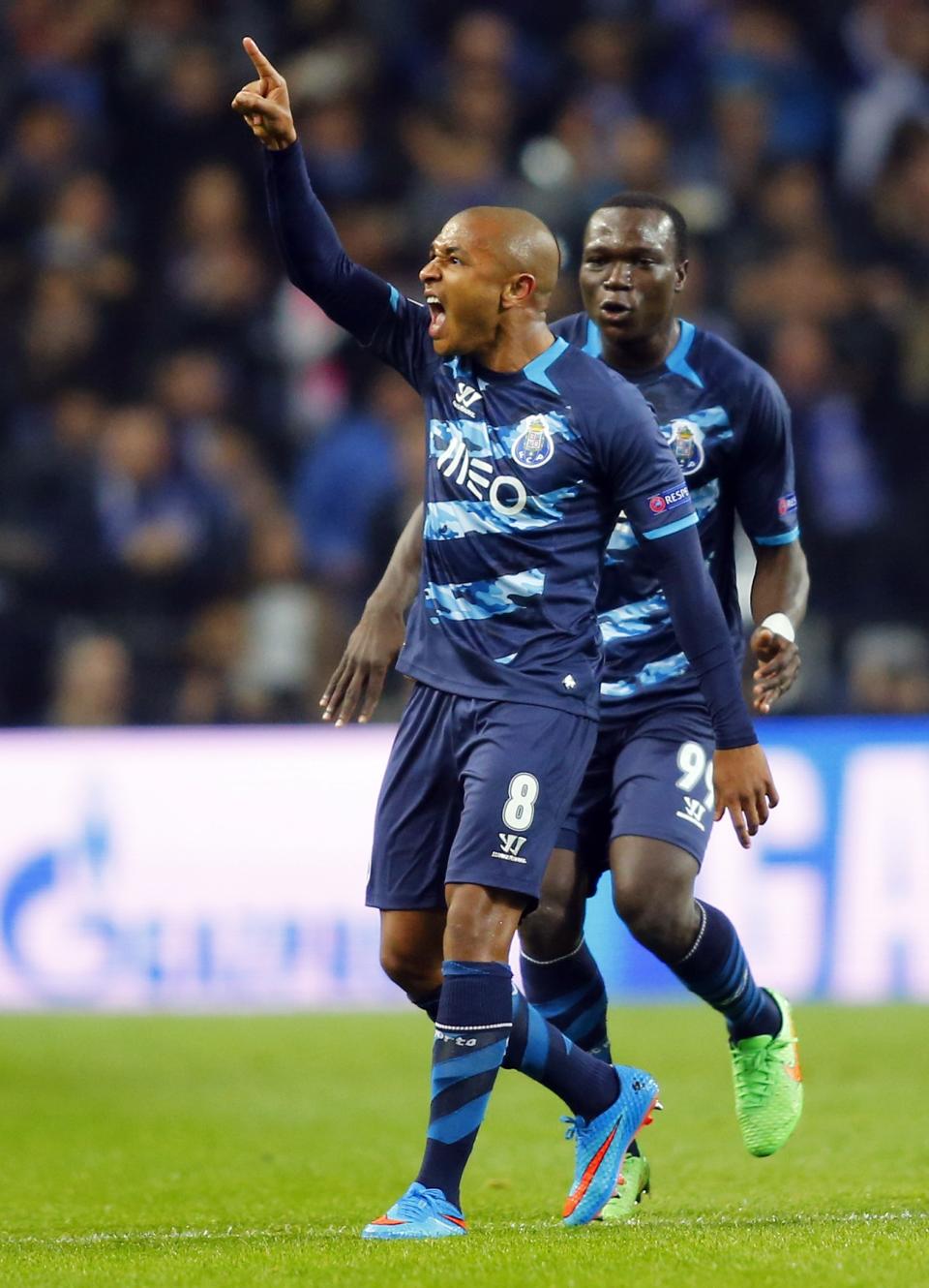 Porto's Yacine Brahimi (L) celebrates his goal against FC Basel with his teammate Vincent Aboubakar during their Champions League round of 16 second leg soccer match at Dragao stadium in Porto, March 10, 2015. REUTERS/Miguel Vidal (PORTUGAL - Tags: SPORT SOCCER)