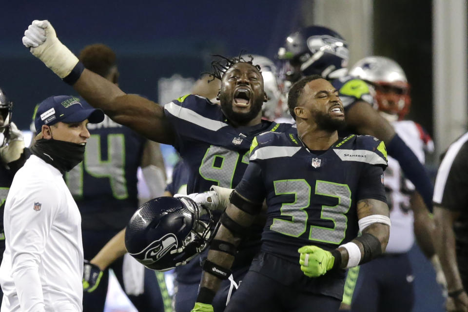 Seattle Seahawks' Jamal Adams (33) and L.J. Collier, left, celebrate after the Seahawks beat the New England Patriots 35-30. (AP Photo/John Froschauer)