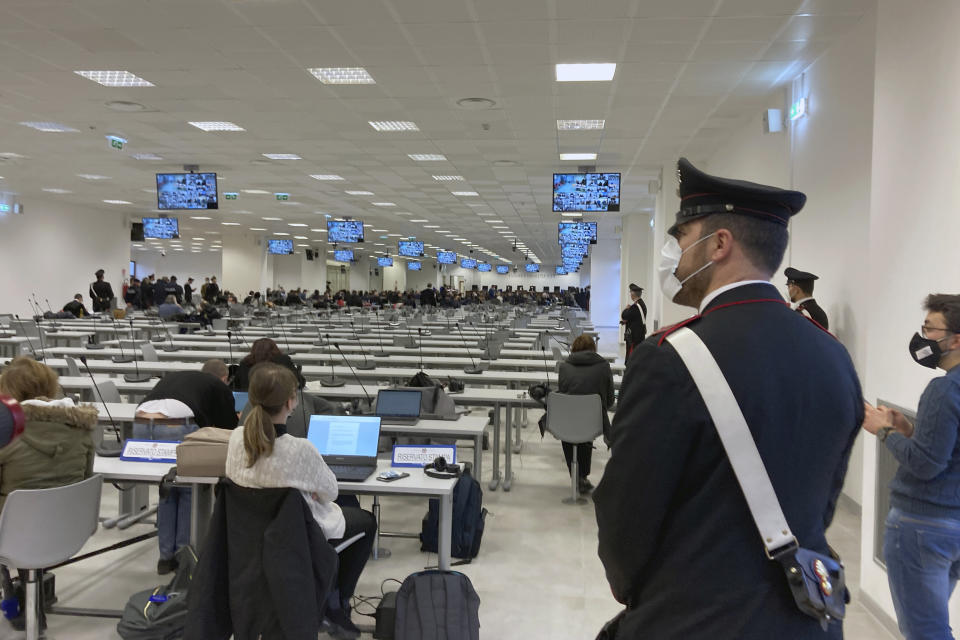 A Carabinieri police officer wearing a face mask to curb the spread of COVID-19 stands guard during the first hearing of a maxi-trial against more than 300 defendants of the ‘ndrangheta crime syndicate, in a specially constructed bunker near the Calabrian town of Lamezia Terme, southern Italy, Wednesday, Jan. 13, 2021. A maxi-trial opened Wednesday in southern Italy against the ‘ndrangheta crime syndicate, arguably the world's richest criminal organization that quietly amassed power in Italy as the Sicilian Mafia lost its influence. (AP Photo/Andrea Rosa)