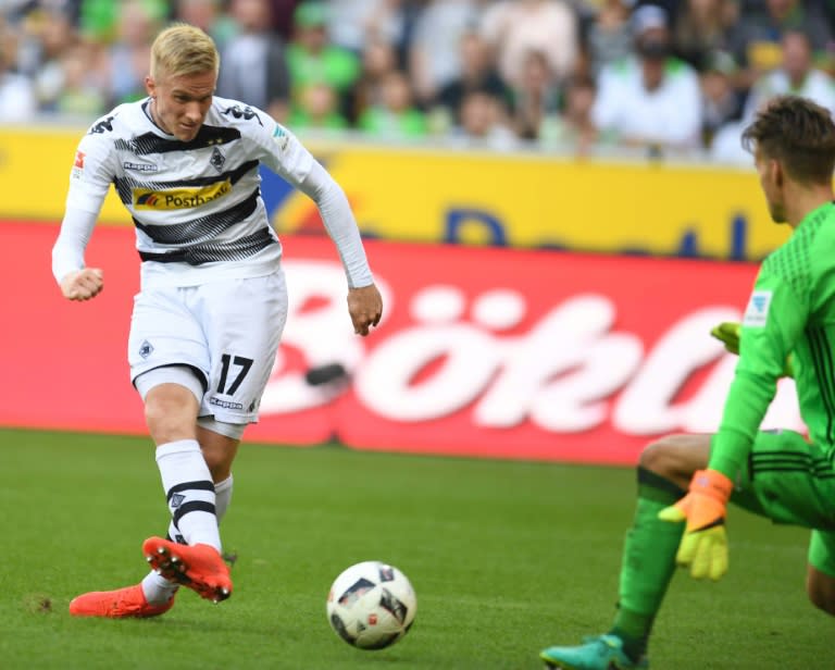 Moenchengladbach's defender Oscar Wendt (L) scores against Ingolstadt´s Norwegian goalkeeper Oerjan Nyland