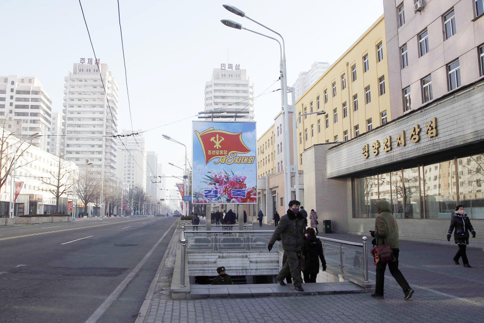 People walk past a billboard announcing the 8th Congress of the Workers Party along a main street of the Central District in Pyongyang, North Korea, on Wednesday, Jan., 6, 2021. The Workers’ Party Congress is one of the North’s biggest propaganda spectacles and is meant to help leader Kim Jong Un show his people that he’s firmly in control and boost unity in the face of COVID-19 and other growing economic challenges. (AP Photo/Cha Song Ho)