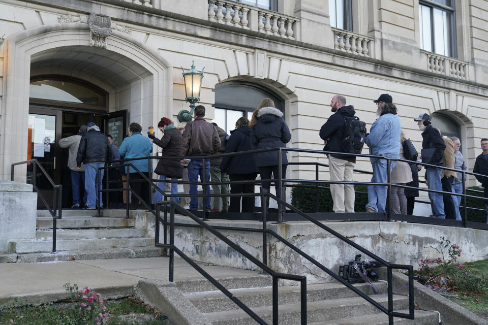 People wait to enter the Carroll County Courthouse, Tuesday, Nov. 22, 2022, in Delphi, Ind. An Indiana judge will hear if sealed court documents with evidence that led to a man's arrest in the 2017 slayings of two teenage girls will be publicly released. Richard Matthew Allen, a 50-year-old of Delphi, Indiana, was charged last month with two counts of murder in the killings of Liberty German, 14, and Abigail Williams, 13. (AP Photo/Darron Cummings)