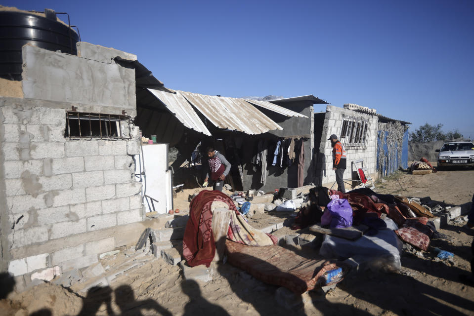 Palestinians salvage what they can from their belongings following Israeli airstrikes on Khan Younis, Gaza Strip, Thursday, Jan. 4, 2024. (AP Photo/Mohammed Dahman)