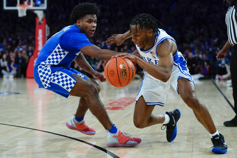 Duke's Jeremy Roach, right, drives past Kentucky's Sahvir Wheeler during the first half of an NCAA college basketball game Tuesday, Nov. 9, 2021, in New York. (AP Photo/Frank Franklin II)