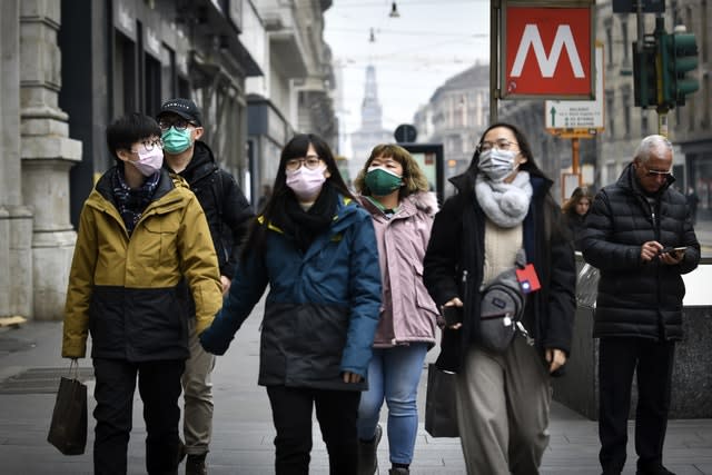 People wear sanitary masks in Milan, Italy