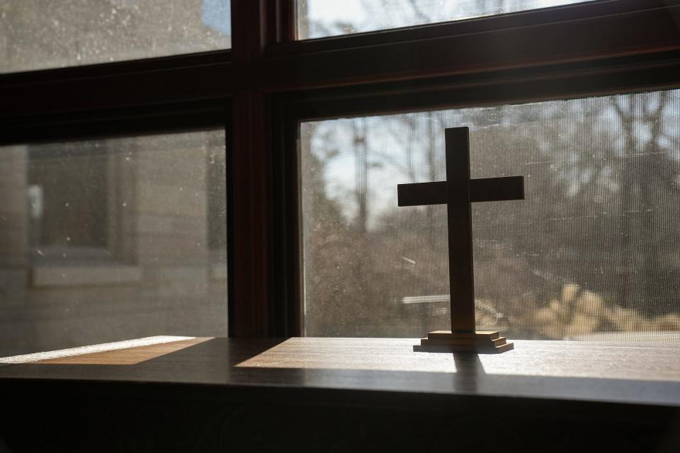 The Church of the Nativity is an Episcopal church in wooded Lantern Hills on the northeast side in Indianapolis. Pictured, a cross sits near a window on Saturday, Feb. 4, 2023.