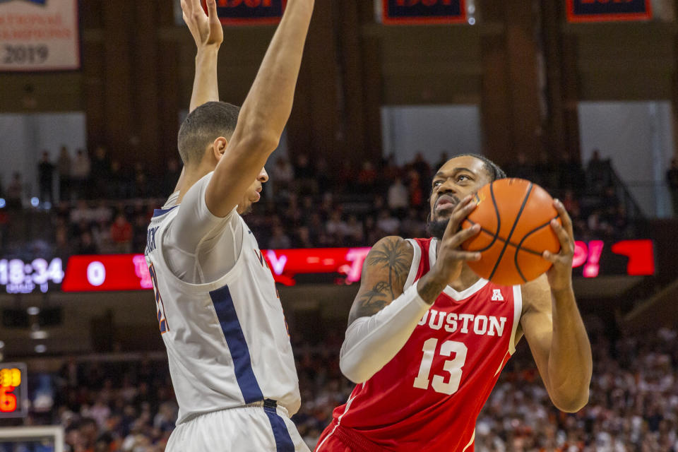 Houston forward J'Wan Roberts (13) looks to the basket as Virginia's Kadin Shedrick (21) defends during the first half of an NCAA college basketball game in Charlottesville, Va., Saturday, Dec. 17, 2022. (AP Photo/Erin Edgerton)