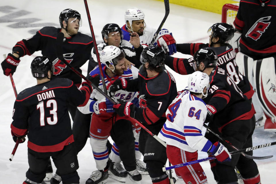 New York Rangers and Carolina Hurricanes get into a scuffle during the first period during Game 2 of an NHL hockey Stanley Cup second-round playoff series Friday, May 20, 2022, in Raleigh, N.C. Both teams were penalized on the play. (AP Photo/Chris Seward)