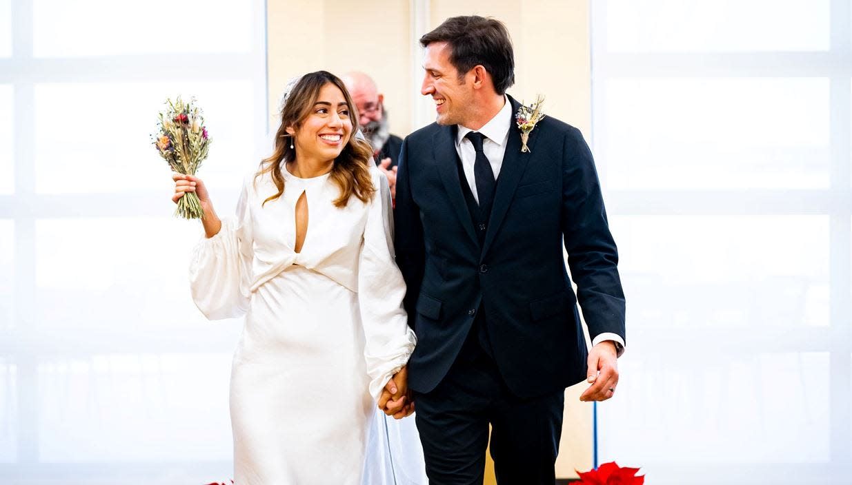 Alexa (left) and Jordan Jur get married in a small ceremony in the community room at the Timnath Town Center after snow threw a wrench in their plans for a courthouse wedding Thursday, Dec. 22, 2022.