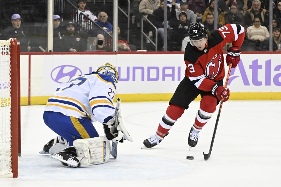 New Jersey Devils right wing Tyler Toffoli (73) skates in against Buffalo Sabres goaltender Devon Levi (27) during the second period of an NHL hockey game Saturday, Nov. 25, 2023, in Newark, N.J. (AP Photo/Bill Kostroun)