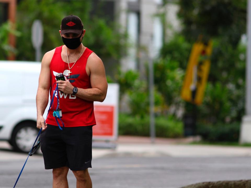 Man walks dog - Hawaii - March 2020