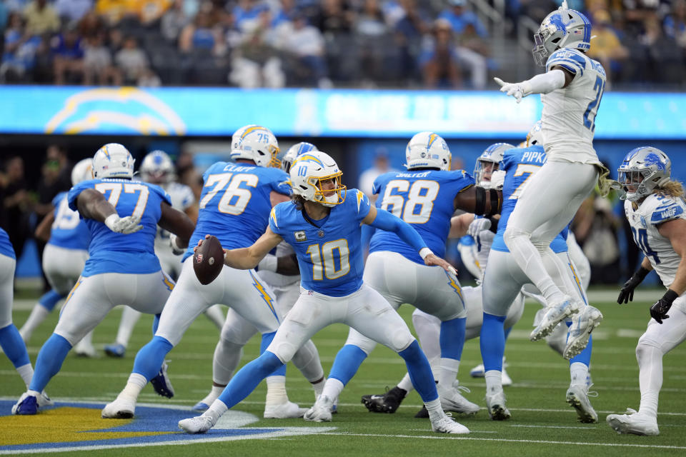 Los Angeles Chargers quarterback Justin Herbert (10) throws under pressure during the first half an NFL football game against the Detroit Lions Sunday, Nov. 12, 2023, in Inglewood, Calif. (AP Photo/Ashley Landis)