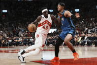 Toronto Raptors' Pascal Siakam (43) drives at Orlando Magic's Paolo Banchero during the first half of an NBA basketball game, Saturday, Dec. 3, 2022 in Toronto. (Chris Young/The Canadian Press via AP)