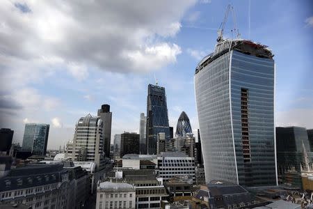 The Walkie Talkie skyscraper (R) is seen during its construction in central London, in this September 3, 2013 file photo. REUTERS/Stefan Wermuth/Files