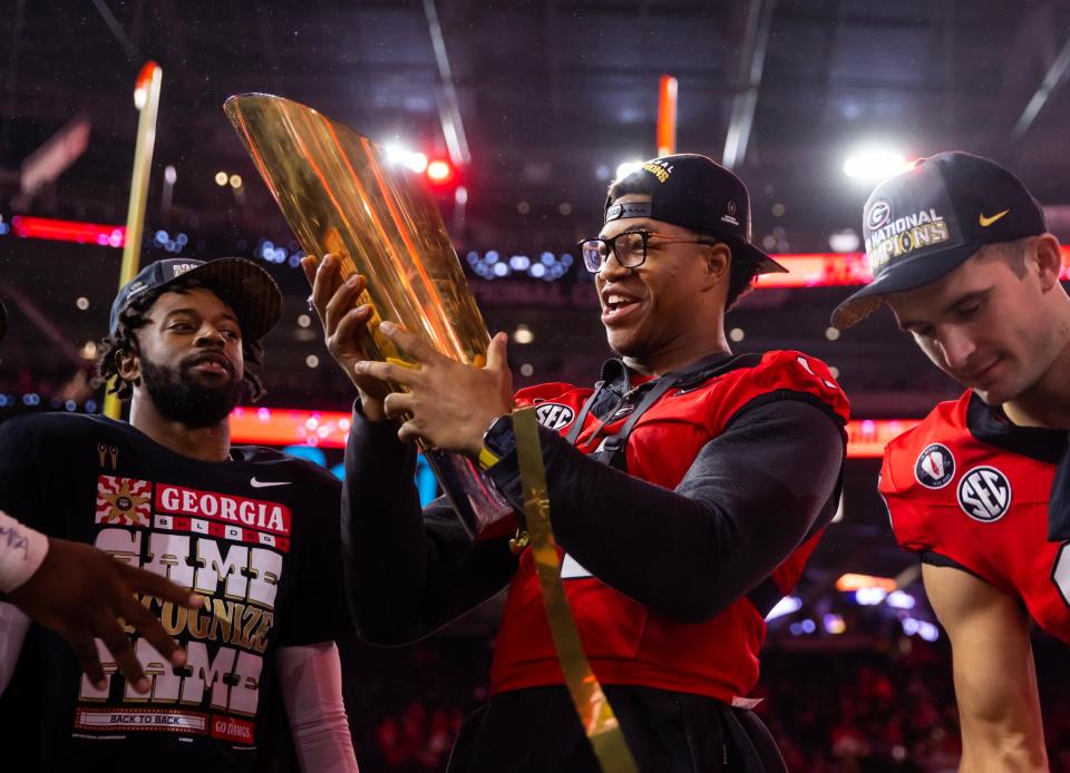 Jan 9, 2023; Inglewood, CA, USA; Georgia Bulldogs linebacker Nolan Smith (4) celebrates with the championship trophy after defeating the TCU Horned Frogs during the CFP national championship game at SoFi Stadium. Mandatory Credit: Mark J. Rebilas-USA TODAY Sports