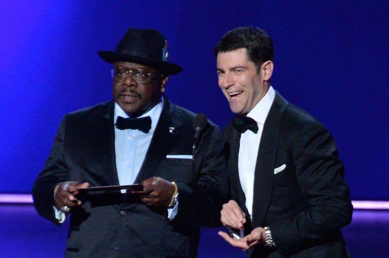 Max Greenfield (R), seen with Cedric the Entertainer, stars in "Unfrosted." File Photo by Jim Ruymen/UPI