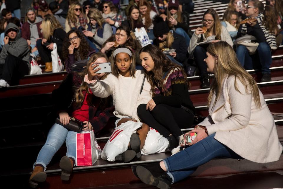 A group of teens take a photograph with a smartphone in Times Square, December 1, 2017 in New York City. The photo-sharing app Instagram has released data for its most-Instagrammed cities and locations for 2017. New York City is ranked number one, with Moscow and London coming in second and third. Among the most photographed locations in New York City were the Brooklyn Bridge, Times Square and Central Park.