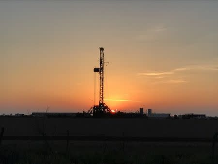 FILE PHOTO: A oil drilling rig is seen at sunrise near Midland, Texas, U.S., May 3, 2017. REUTERS/Ernest Scheyder/File Photo