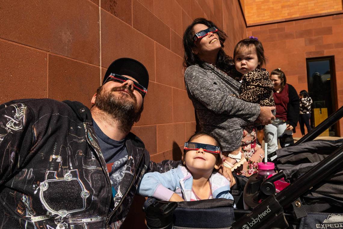 Alex Blankenship watches the solar eclipse with his wife Ikumi and his daughters Eli, 6, and Hana, 1, during the Annular Solar Eclipse event at the Fort Worth Museum of Science & History on Saturday, Oct. 14, 2023.