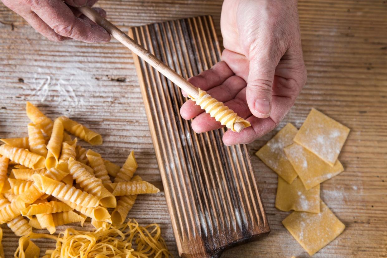 hands making pasta shapes